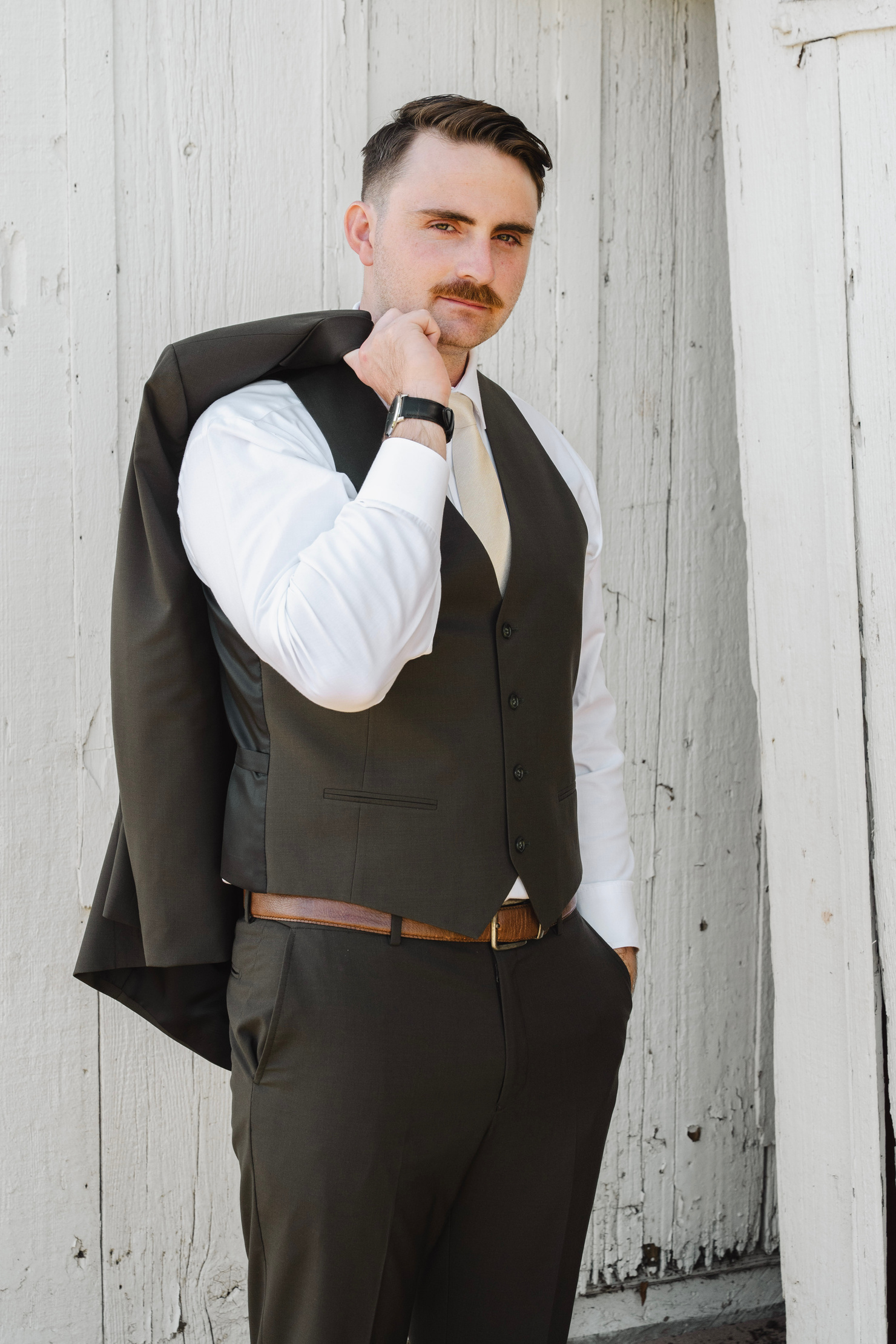 Troy Koennecker wearing a waistcoat with a jacket over his shoulder